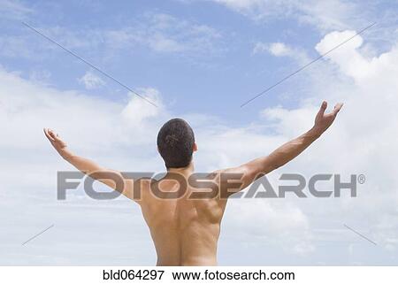 Stock Photo - Bare chested Hispanic man with arms out. Fotosearch