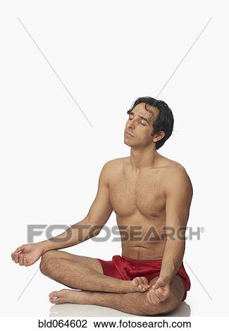 Stock Image - Bare chested Middle Eastern man meditating. Fotosearch