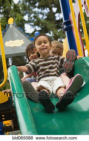 Children sliding in playground View Large Photo Image Stock Photo - Children sliding in playground. Fotosearch