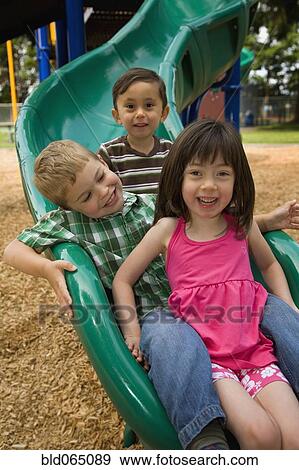 Children sliding in playground View Large Photo Image Stock Photo - Children sliding in playground. Fotosearch