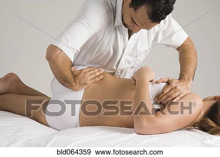 Chiropractor adjusting woman’s back View Large Photo Image Stock Photo - Chiropractor adjusting woman’s back. Fotosearch