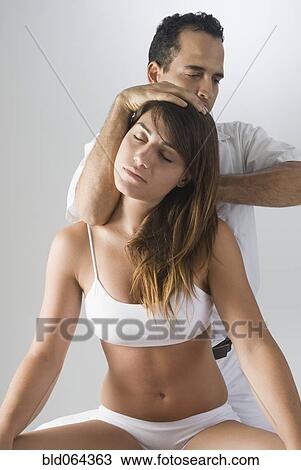 Chiropractor adjusting woman’s neck View Large Photo Image Stock Image - Chiropractor adjusting woman’s neck. Fotosearch