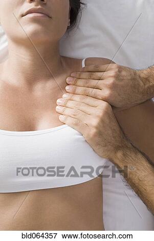 Stock Photo - Chiropractor adjusting woman’s shoulder. Fotosearch