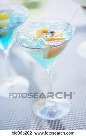 Stock Image - Close up of exotic cocktail in martini glass. Fotosearch