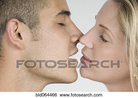 Stock Photograph - Close up of Hispanic couple kissing. Fotosearch