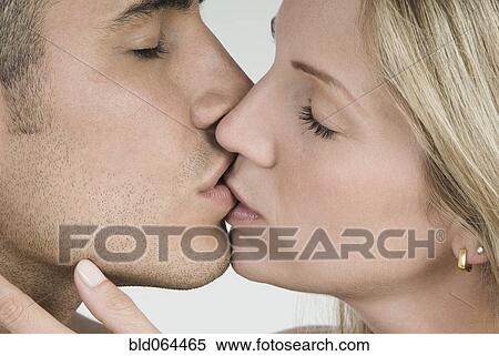 Stock Photography - Close up of Hispanic couple kissing. Fotosearch