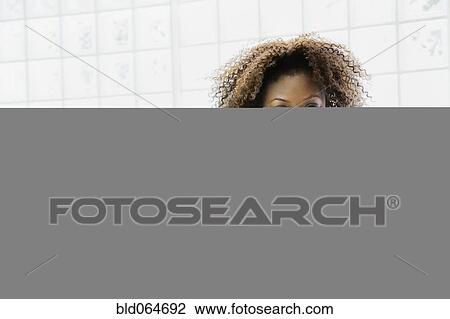 Stock Image - Confident African woman in bathrobe. Fotosearch