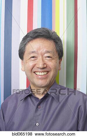 Confident Asian man smiling View Large Photo Image Stock Photo - Confident Asian man smiling. Fotosearch