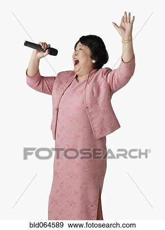 Stock Photo - Confident Asian woman singing. Fotosearch