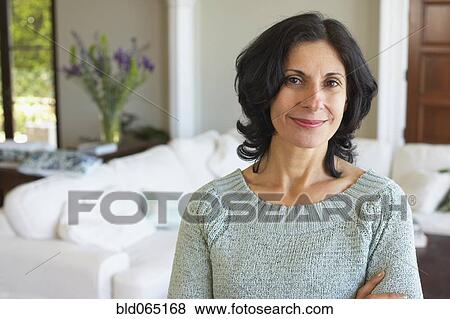 Confident Middle Eastern woman in living room View Large Photo Image Stock Photo - Confident Middle Eastern woman in living room. Fotosearch