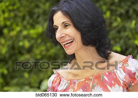 Stock Image - Confident Middle Eastern woman smiling. Fotosearch