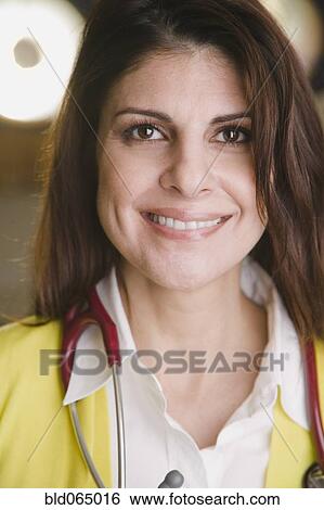 Confident mixed race doctor smiling View Large Photo Image Stock Photograph - Confident mixed race doctor smiling. Fotosearch