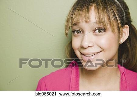 Confident mixed race teenage girl smiling View Large Photo Image Stock Image - Confident mixed race teenage girl smiling. Fotosearch