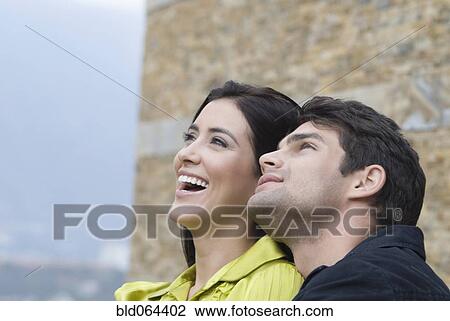 Curious Hispanic couple looking up View Large Photo Image Stock Image - Curious Hispanic couple looking up. Fotosearch