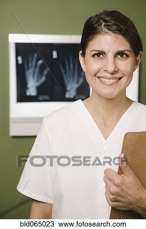 Stock Image - Doctor with medical chart and x-rays. Fotosearch