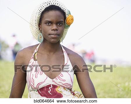 Picture - Fashionable African woman sitting in park. Fotosearch