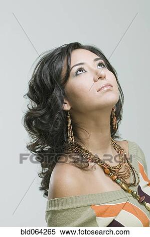 Fashionable Hispanic woman looking up View Large Photo Image Stock Photography - Fashionable Hispanic woman looking up. Fotosearch