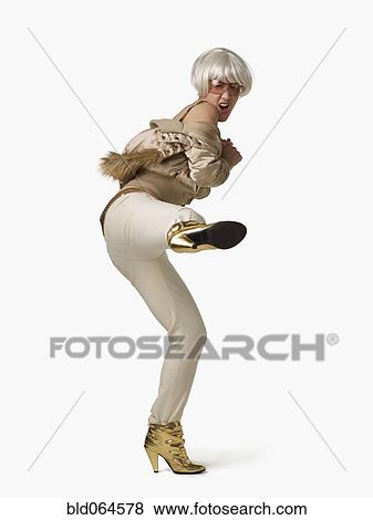 Stock Photo - Glamorous Asian woman kicking. Fotosearch