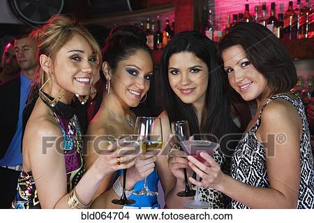 Picture - Group of women drinking cocktails nightclub. Fotosearch