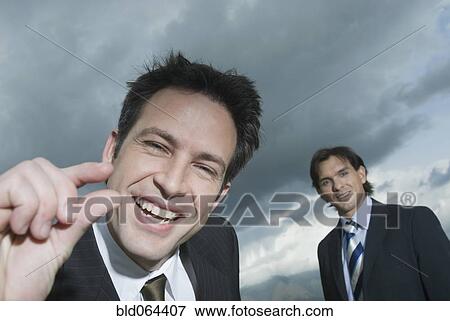 Stock Photo - Hispanic businessman making pinching motion. Fotosearch