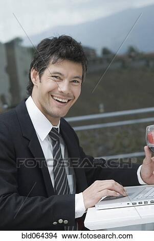 Hispanic businessman typing on laptop View Large Photo Image Picture - Hispanic businessman typing on laptop. Fotosearch