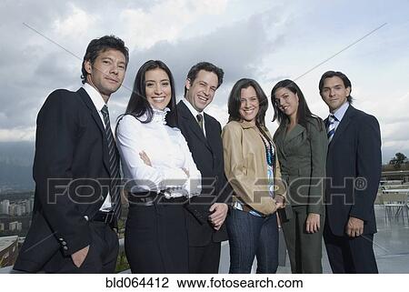 Stock Image - Hispanic co-workers standing in row. Fotosearch