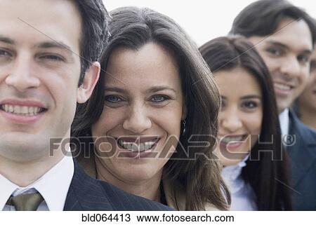 Stock Image - Hispanic co-workers standing in row. Fotosearch