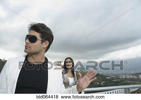 Stock Photo - Hispanic couple arguing outdoors. Fotosearch