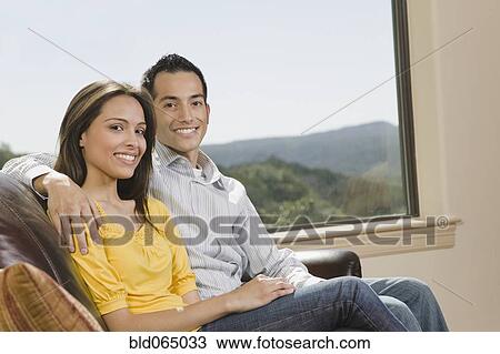 Hispanic couple hugging in living room View Large Photo Image Stock Image - Hispanic couple hugging in living room. Fotosearch