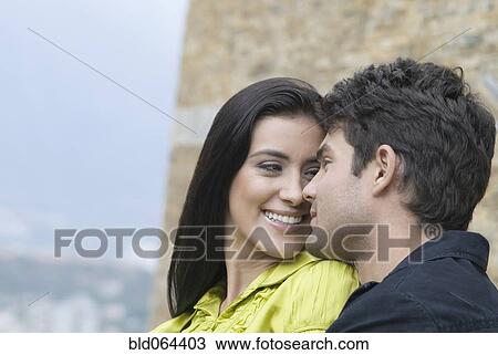 Stock Image - Hispanic couple looking at each other. Fotosearch