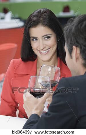 Stock Photo - Hispanic couple on date drinking wine. Fotosearch