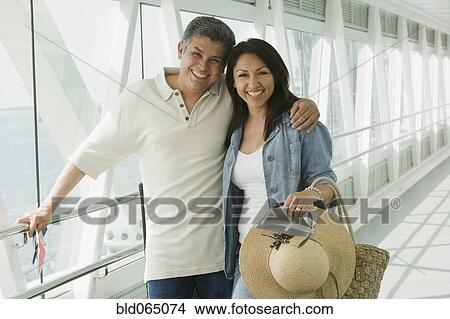 Hispanic couple standing in airport View Large Photo Image Picture - Hispanic couple standing in airport. Fotosearch