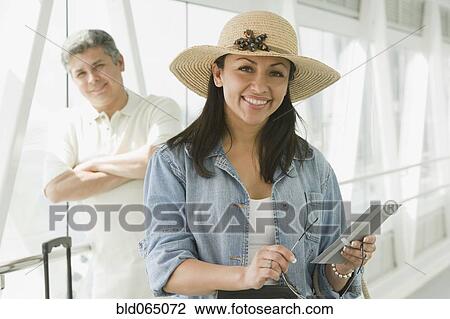 Hispanic couple waiting in airport View Large Photo Image Stock Image - Hispanic couple waiting in airport. Fotosearch