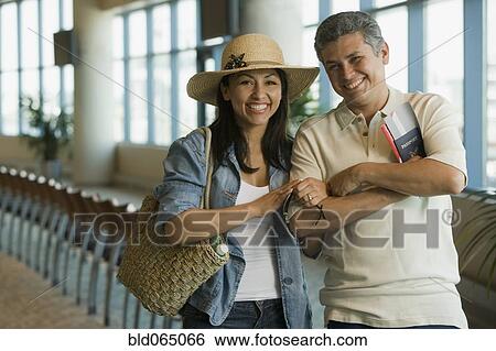 Hispanic couple waiting in airport View Large Photo Image Stock Photograph - Hispanic couple waiting in airport. Fotosearch