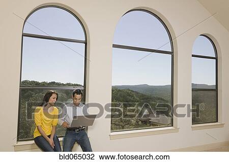 Hispanic couple working on laptop together View Large Photo Image Stock Image - Hispanic couple working on laptop together. Fotosearch