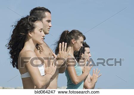 Hispanic couples doing yoga at beach View Large Photo Image Stock Photo - Hispanic couples doing yoga at beach. Fotosearch