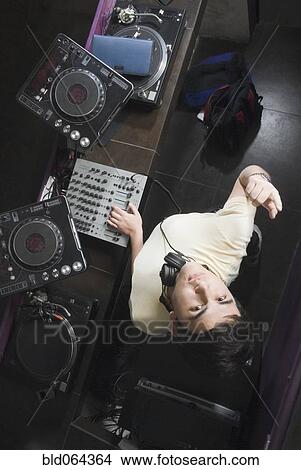 Picture - Hispanic DJ performing in nightclub. Fotosearch