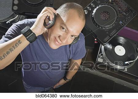 Hispanic DJ performing in nightclub View Large Photo Image Stock Image - Hispanic DJ performing in nightclub. Fotosearch