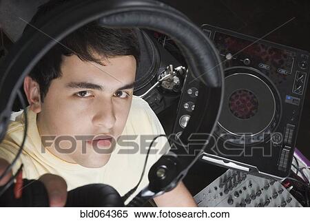 Stock Photography - Hispanic DJ performing in nightclub. Fotosearch