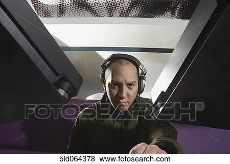 Hispanic DJ wearing headphones View Large Photo Image Stock Photo - Hispanic DJ wearing headphones. Fotosearch