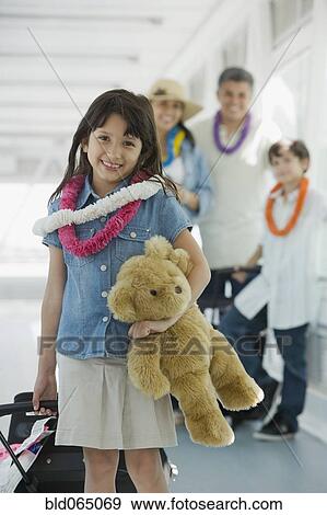 Hispanic family traveling in airport View Large Photo Image Stock Photo - Hispanic family traveling in airport. Fotosearch