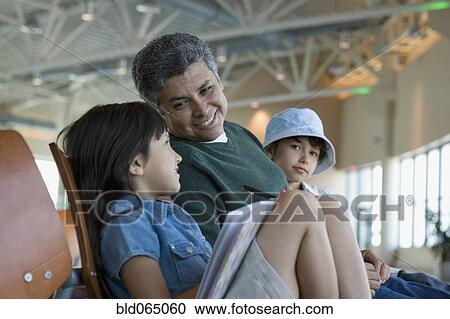 Hispanic family waiting in airport View Large Photo Image Stock Image - Hispanic family waiting in airport. Fotosearch