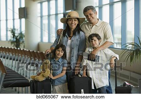 Stock Photo - Hispanic family waiting in airport. Fotosearch