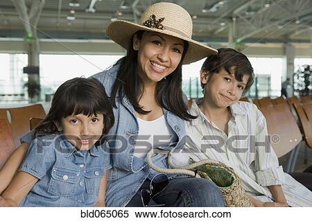 Stock Photography - Hispanic family waiting in airport. Fotosearch