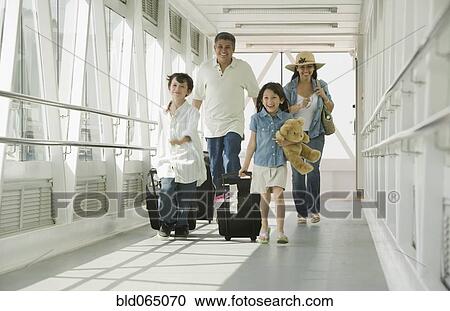 Hispanic family walking through airport View Large Photo Image Stock Image - Hispanic family walking through airport. Fotosearch