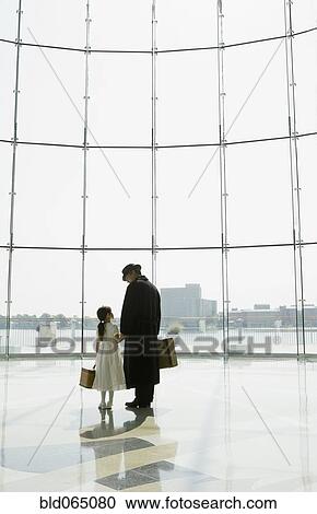 Hispanic father and daughter waiting in airport View Large Photo Image Stock Image - Hispanic father and daughter waiting in airport. Fotosearch