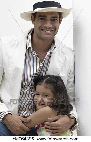 Hispanic father hugging smiling daughter View Large Photo Image Stock Photography - Hispanic father hugging smiling daughter. Fotosearch