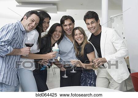 Stock Photography - Hispanic friends drinking cocktails. Fotosearch