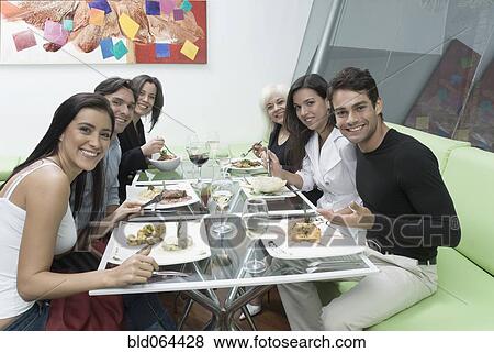 Hispanic friends eating in restaurant View Large Photo Image Stock Photo - Hispanic friends eating in restaurant. Fotosearch