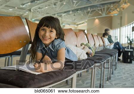 Hispanic girl coloring in airport View Large Photo Image Stock Image - Hispanic girl coloring in airport. Fotosearch